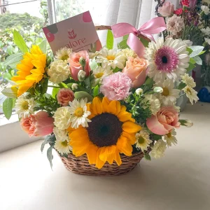 Canasta de mimbre con girasoles, gerberas, rosas y margaritas