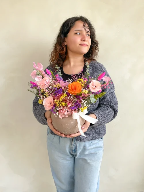 maceta de flroes seas con modelo por el dia de la madre chica con una maceta de flores eternas en colores llamativos