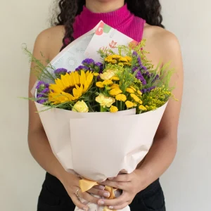 Ramo pequeño de girasol y flores amarillas y moradas de temporada