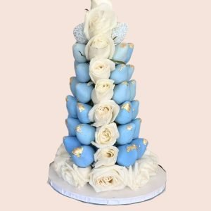 Torre de fresas bañadas en chocolate azul y blanco con rosas blancas para eventos