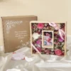 caja con un cuadro de flores secas y fotografia
