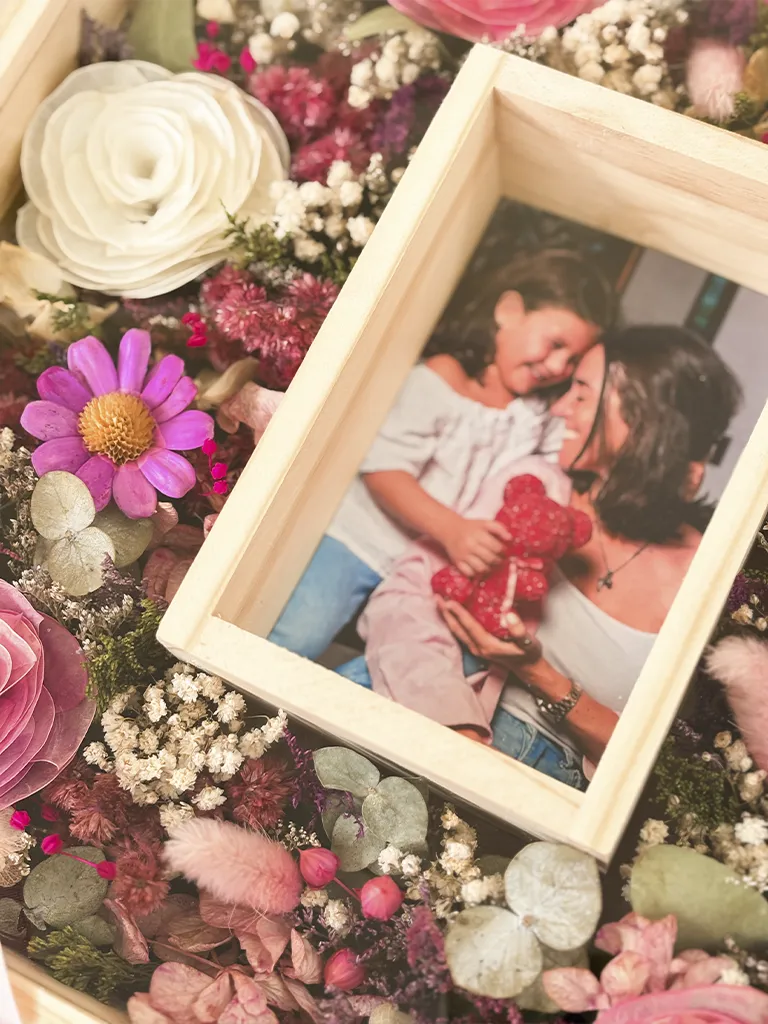 Detalle de foto de madre e hija en cuadro de flores eternas y secas