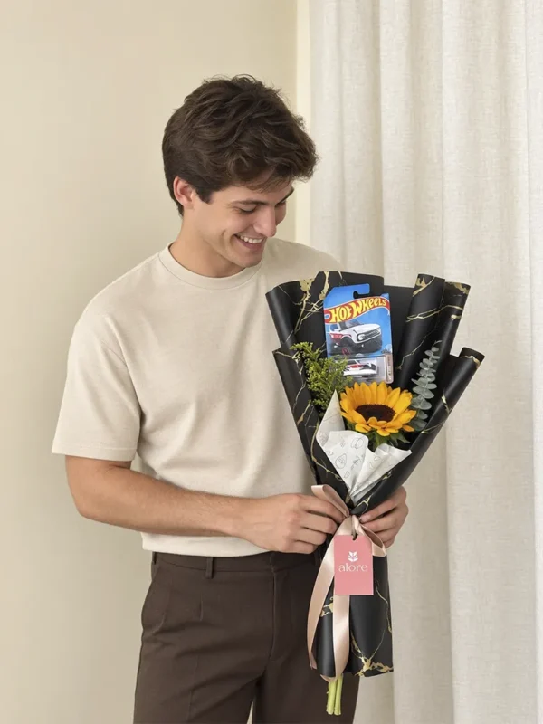 Ramo con girasol y auto Hot Wheels en papel negro para regalo a hombre